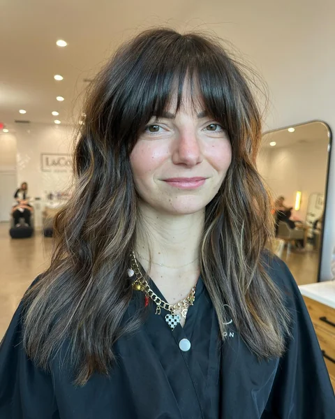 Medium Wavy Brunette Hair with Wispy Curtain Bangs