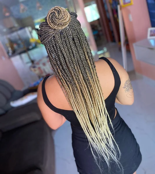 Box Braids Styled into a Bun with Curly Tail
