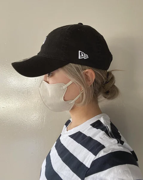 Blonde Low Bun with New Era Baseball Cap