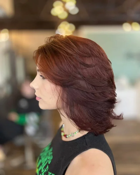 Rich Mahogany Layered Lob with Sweeping Movement