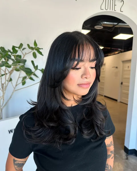 Long Black Layered Hair with Wispy Side-Swept Bangs