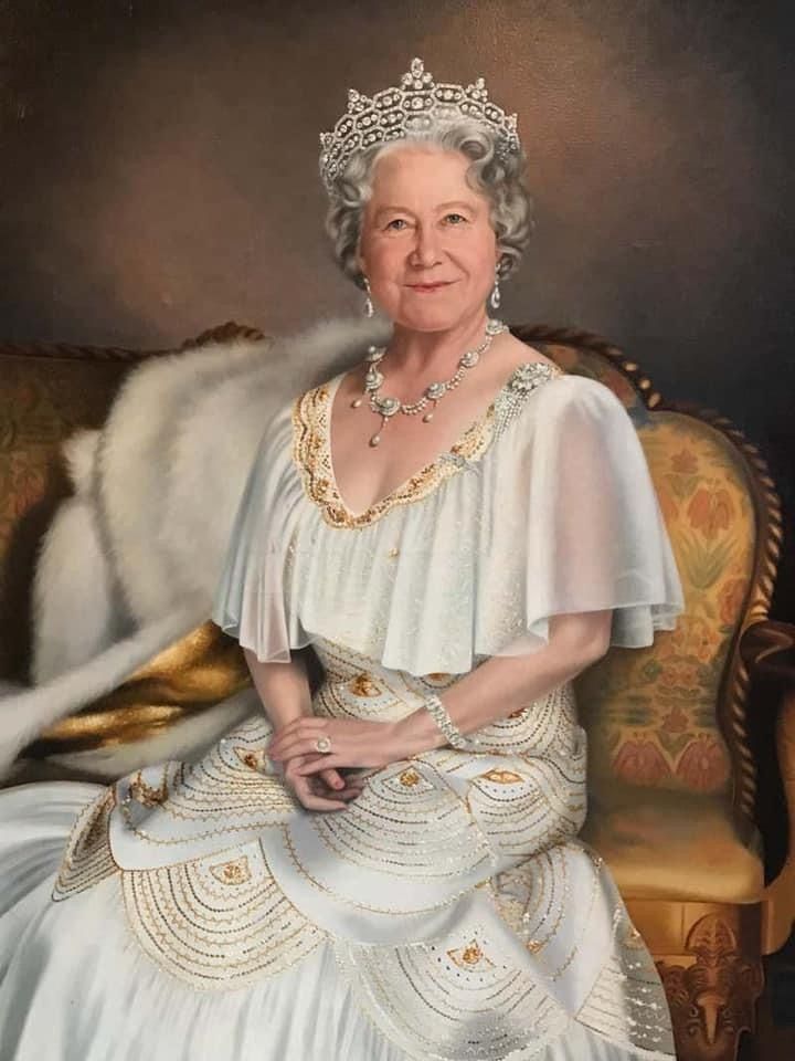 This may contain: an older woman in a white dress and tiara sitting on a couch with a fur stole around her neck