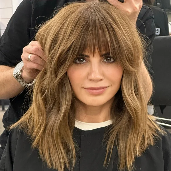 Medium Golden Brown Wavy Hair with Wispy Bangs