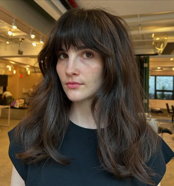 Medium Dark Wavy Hair with Curtain Bangs