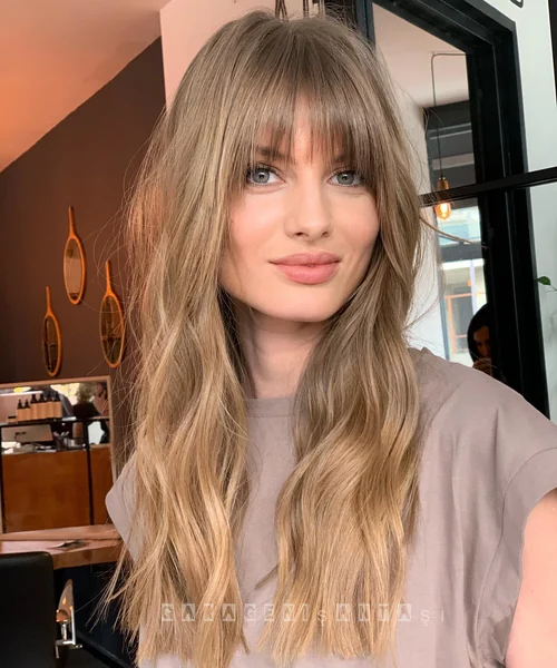 Long Blonde Wavy Hair with Wispy Curtain Bangs