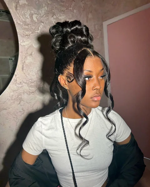 High Bun Updo with Face-Framing Curls