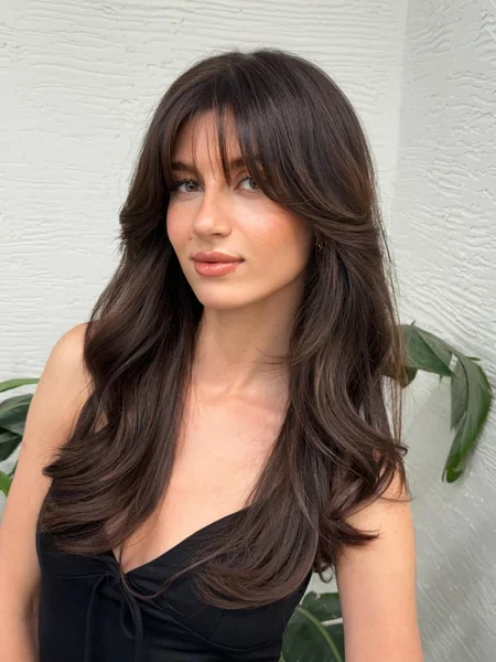 Wavy Dark Hair with Side-Swept Bangs