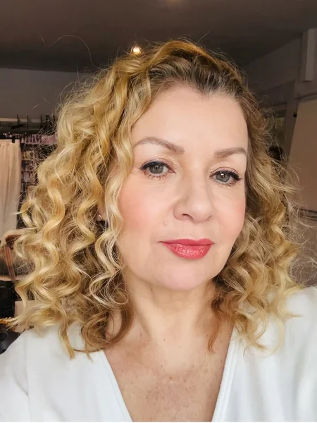 Bouncy Honey Blonde Curls with Shoulder-Skimming Length