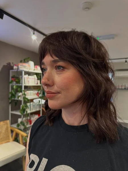 Dark Brunette Wavy Shag with Full Bangs
