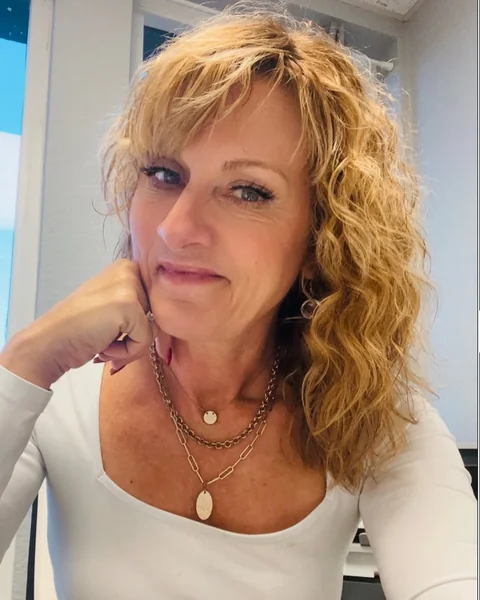 Layered Blonde Shag with Natural Curls and Bangs