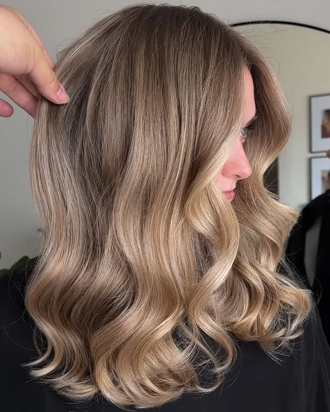 Luxurious Medium Wavy Cut with Golden Balayage
