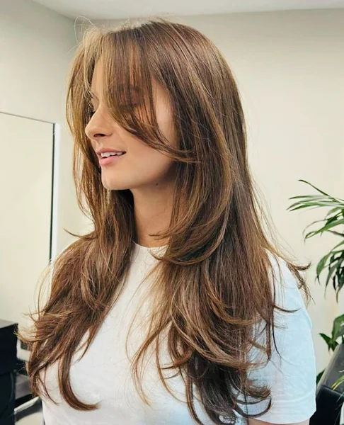 Polished Brunette Long Layers with Voluminous Curtain Bangs