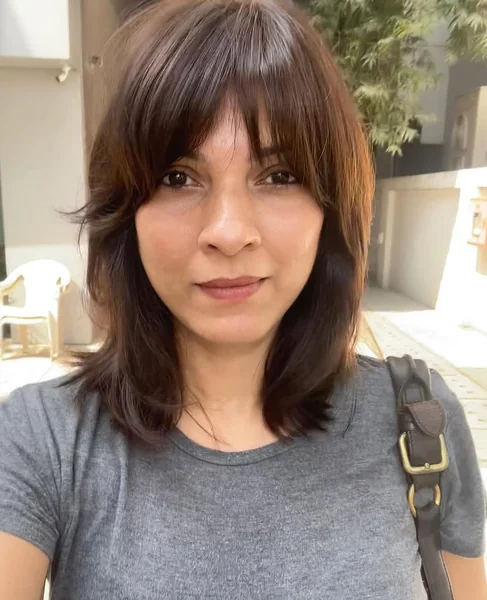 Shoulder-Length Layered Bob with Full Fringe