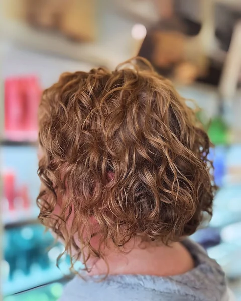 Sun-Kissed Copper Curly Bob with Natural Volume