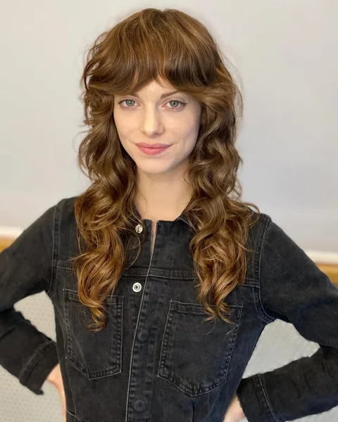 Voluminous Copper Long Layers with Curtain Bangs