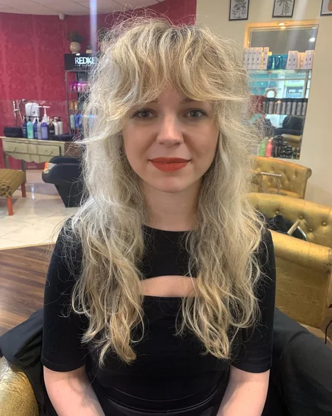 Voluminous Wavy Blonde Shag with Curtain Bangs