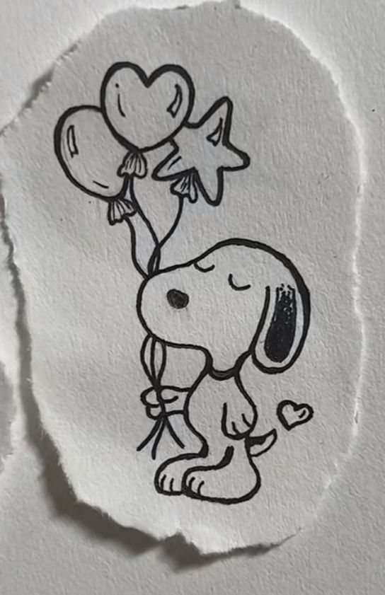 This may contain: a piece of paper with a drawing of a dog holding balloons on it's head