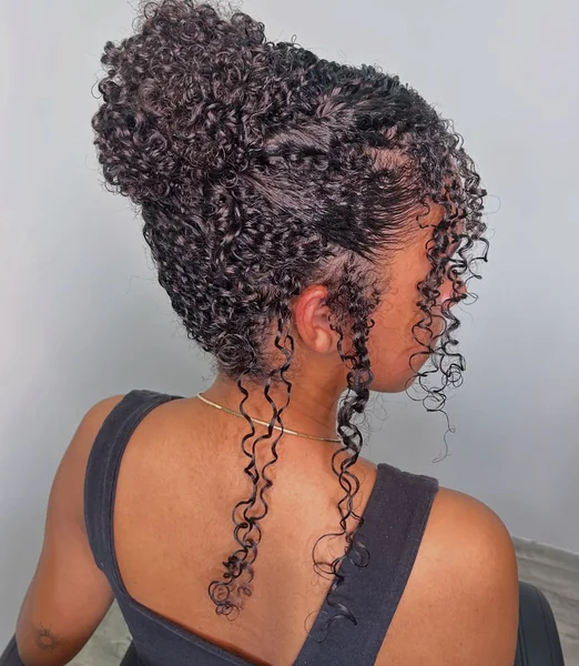 Chic Curly High Bun with Face-Framing Tendrils