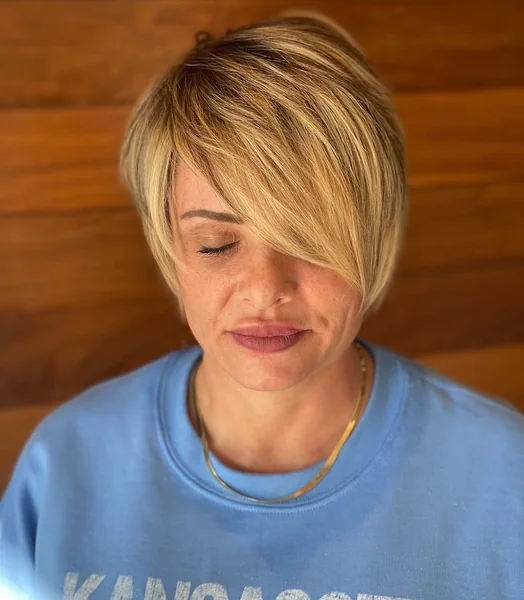 Chic Honey-Blonde Long Pixie with Sweeping Side Fringe