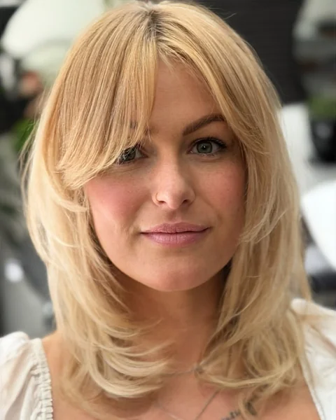 Chic Honey Blonde Layered Cut with Wispy Bangs