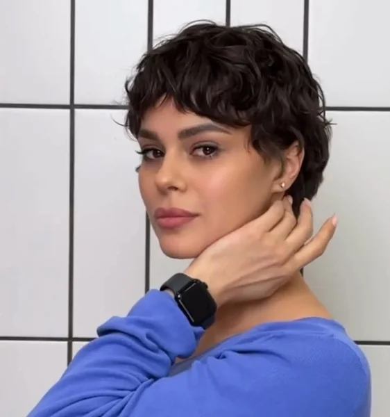 Chic Textured Brunette Pixie with Soft Curly Bangs