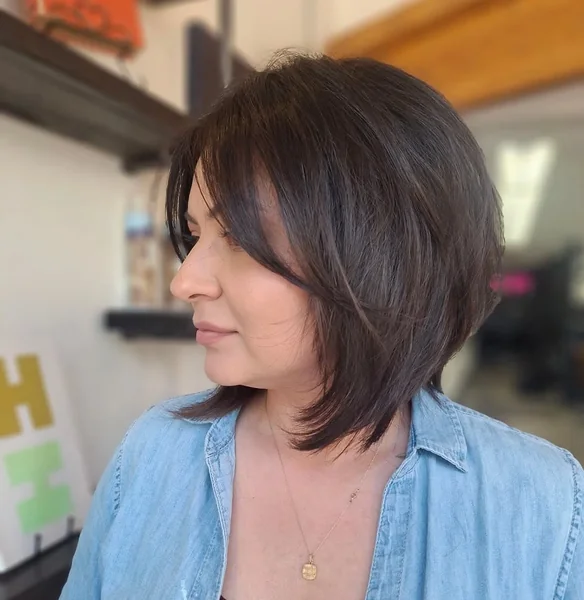 Curly Espresso Stacked Bob with Sun-Kissed Dimensions