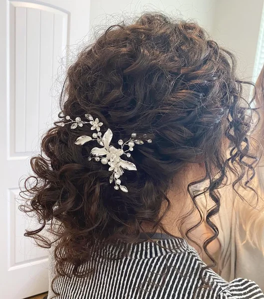 Curly Low Messy Bun with Cascading Ringlet Bangs