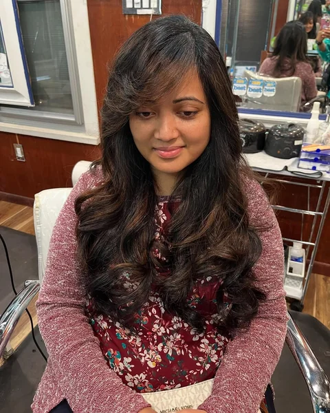Deep Brunette Butterfly Cut with Dramatic Side Bangs