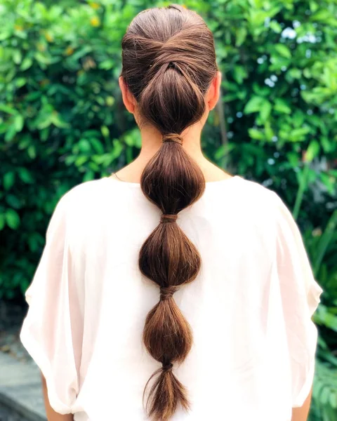 Effortless Textured Blonde Ponytail with Fluffy Curtain Bangs
