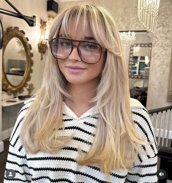 Effortless Honey Blonde Shag with Wispy Curtain Bangs
