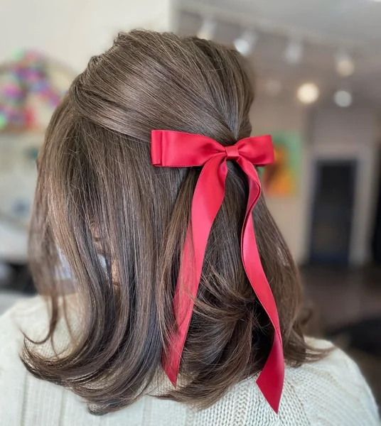 Elegant Half-Up Hairstyle with Classic Red Satin Ribbon