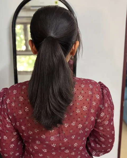 High-Gloss Sculpted Ponytail with Dramatic Ribbon Curl