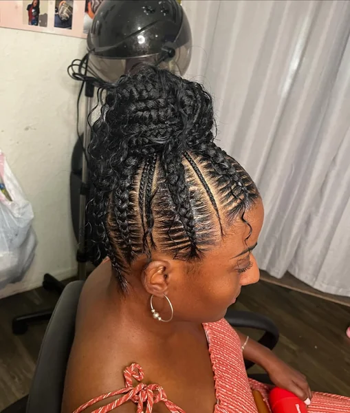 High-Volume Braided Bun with Curly Tendrils