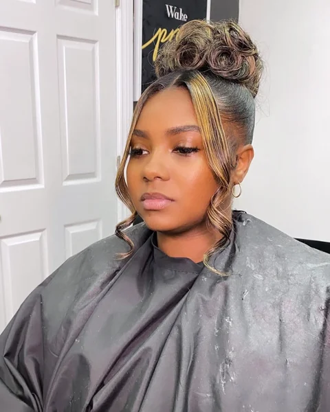 Honey-Highlighted Sculpted Top Knot with Face-Framing tendrils