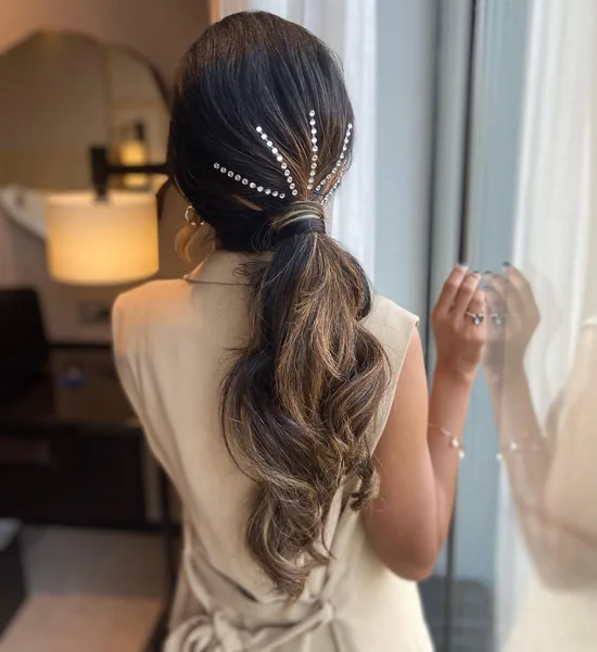 Loose Wavy Low Ponytail with Sparkling Pin Accent