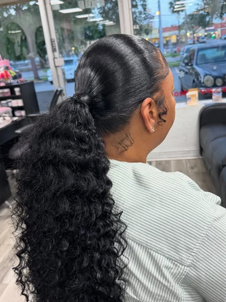 Polished High Ponytail with Voluminous Defined Curls