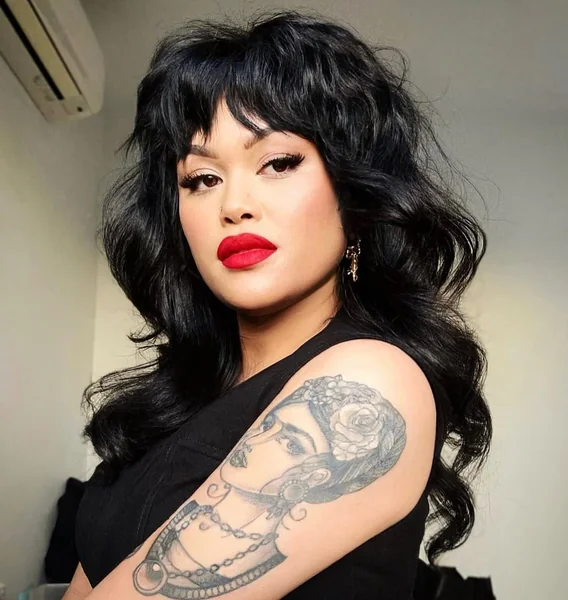 Rich Black Wavy Shag with Full Voluminous Bangs