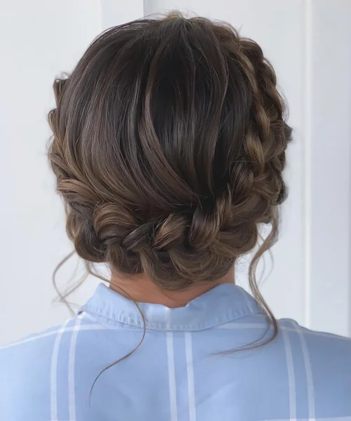 Romantic Low Braided Updo with Soft Wispy Tendrils