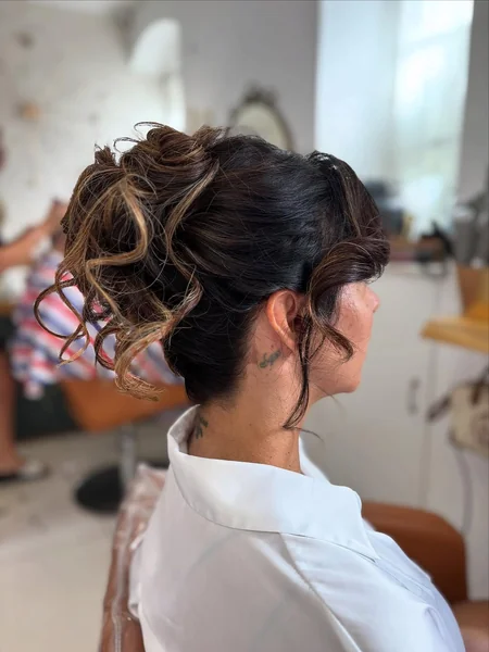 Romantic Messy Bun with Wispy Face-Framing Bangs