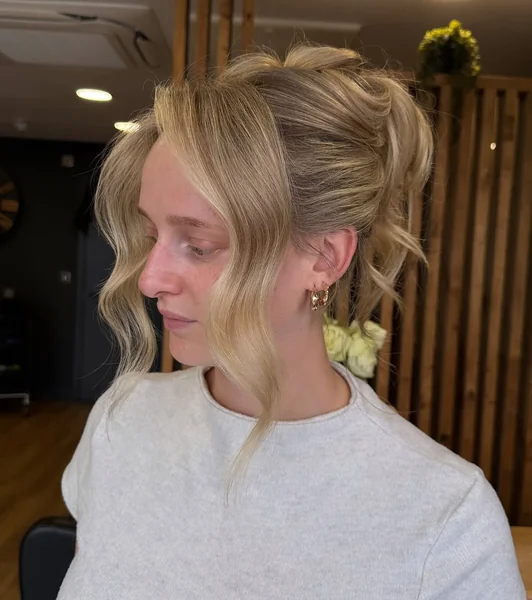 Romantic Tousled Updo with Face-Framing Curtain Bangs