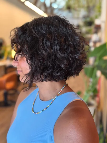 Short Dark Curly Bob with Face-Framing Volume