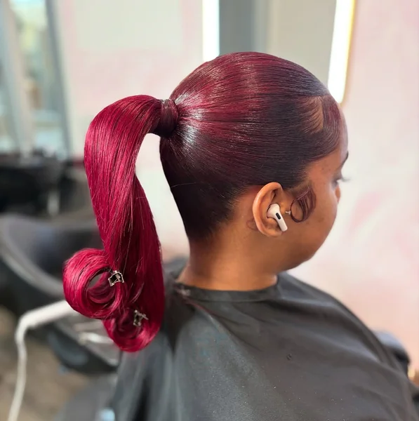 Sleek Low Ponytail with Voluminous Cascade of Curls