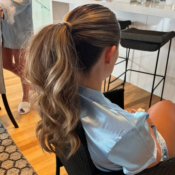 Sleek High Ponytail with Voluminous Wavy Ends