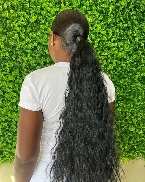 Sleek Low Ponytail with Voluminous Deep Wave Lengths