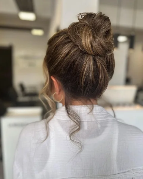 Sleek Top-Knot Messy Bun with Honey Highlights