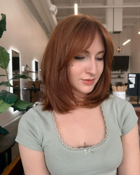Smooth Auburn Lob with Soft Side-Swept Bangs