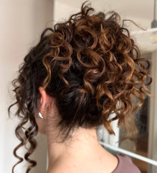 Sophisticated Curly Half-Updo with Golden Leaf Detail