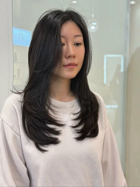 Sophisticated Midnight Raven Layers with Tapered Side-Swept Bangs