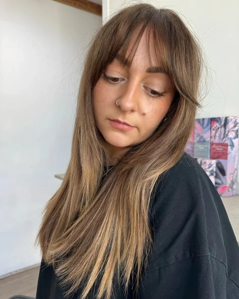 Sun-Kissed Bronde Layers with Wispy Curtain Bangs