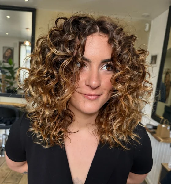 Sun-Kissed Voluminous Curls with Honey Highlights